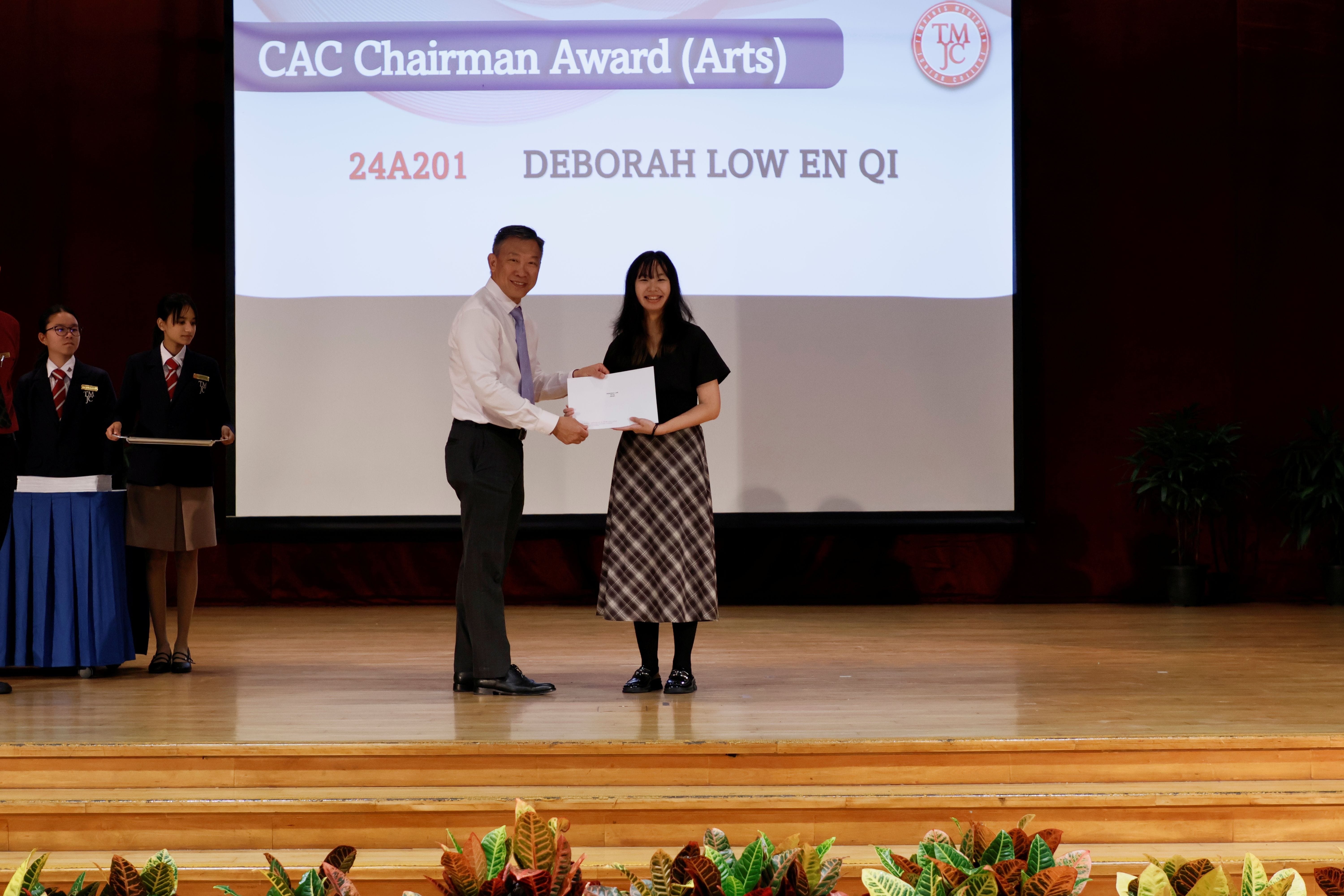Student Deborah Low En Qi from class 24A201 receiving the CAC Chairman Award (Arts) on stage.